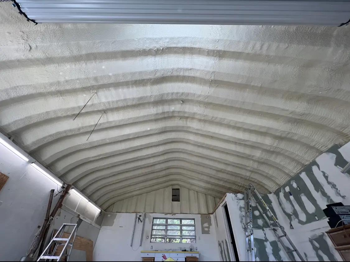 Spray polyurethane foam applied to the underside of a metal roof deck in Gray